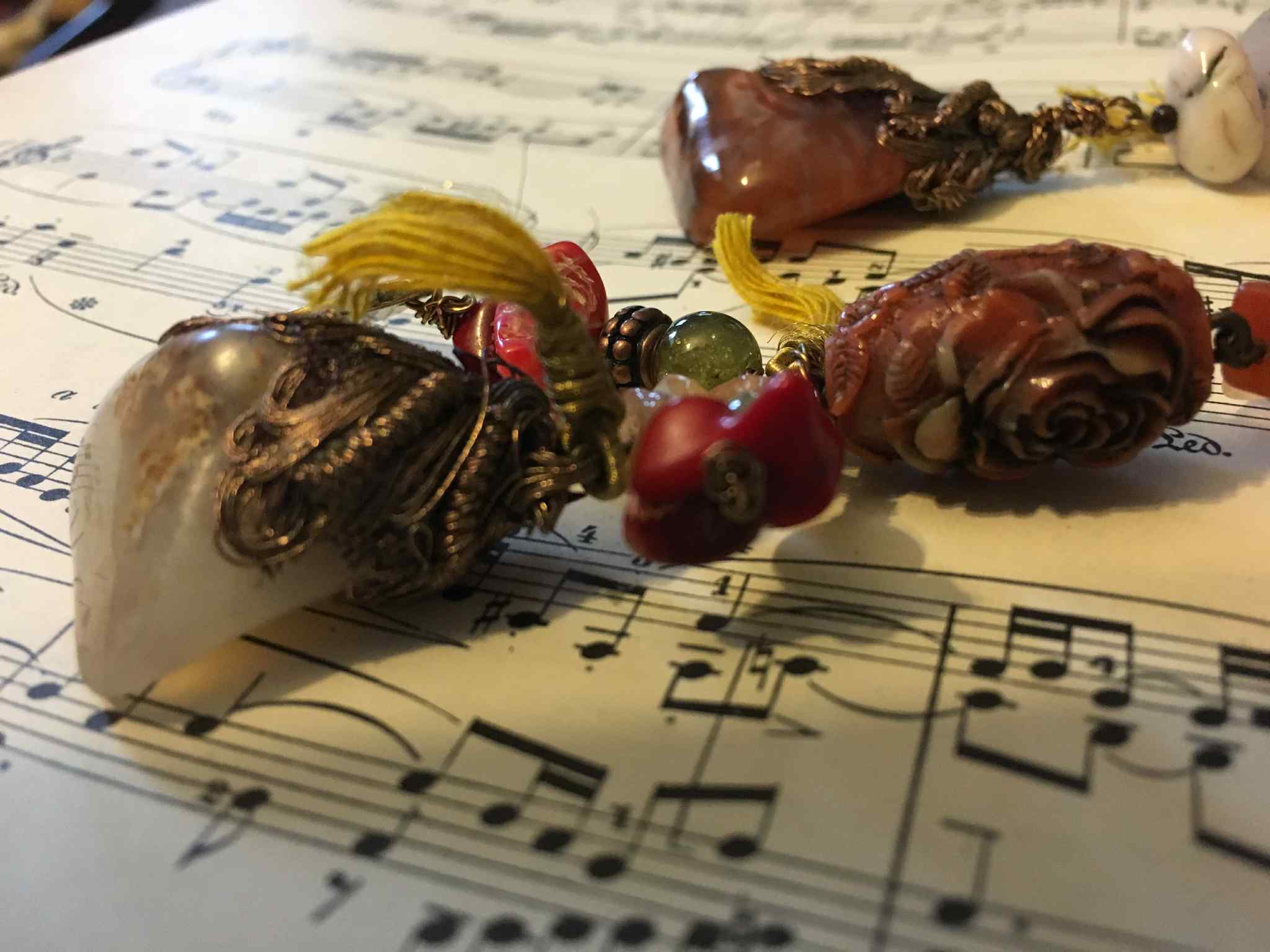 “Opulent Caravan” – Bohemian Silk Ribbon Necklace with Coral, Agate, Carved Rose, and Bronze Charms